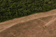 Picture taken with drone of an agricultural machine preparing the soil for planting - Itapua do Oeste city - Rondonia state (RO) - Brazil