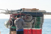 Detail of cargo trolley - man carrying a cart - with beach chairs - Copacabana Beach waterfront - Rio de Janeiro city - Rio de Janeiro state (RJ) - Brazil