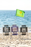 Beach chairs and green flag indicating low risk for swimming in the sea - Copacabana Beach - Rio de Janeiro city - Rio de Janeiro state (RJ) - Brazil