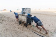 Men pushing cargo trolley - man carrying a cart - with beach chairs - Copacabana Beach waterfront - Rio de Janeiro city - Rio de Janeiro state (RJ) - Brazil