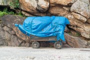 Detail of cargo trolley with material covered with canvas on the edge of Arpoador Beach - Rio de Janeiro city - Rio de Janeiro state (RJ) - Brazil