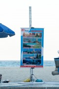 Travel agency poster on Copacabana Beach boardwalk - Rio de Janeiro city - Rio de Janeiro state (RJ) - Brazil