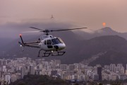 Helicopter taking a tourist flight over Sugarloaf Mountain with Christ the Redeemer in the background - Rio de Janeiro city - Rio de Janeiro state (RJ) - Brazil