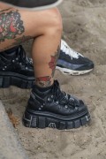 Detail of person wearing boots on Copacabana Beach - Rio de Janeiro city - Rio de Janeiro state (RJ) - Brazil