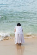 Woman throwing offerings for Yemanja During the party on the day of the Queen of the Sea - Arpoador Beach - Rio de Janeiro city - Rio de Janeiro state (RJ) - Brazil