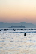 Practitioners of Stand up paddle watching the sunrise - post 6 of Copacabana Beach - Rio de Janeiro city - Rio de Janeiro state (RJ) - Brazil