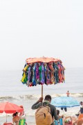 Street vendor with improvised sun umbrella as a display for selling bikinis on Copacabana Beach - Rio de Janeiro city - Rio de Janeiro state (RJ) - Brazil
