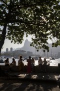 People socializing and drinking sitting by the sea in Short wall of Urca - Rio de Janeiro city - Rio de Janeiro state (RJ) - Brazil