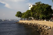 People socializing and drinking sitting by the sea in Short wall of Urca - Rio de Janeiro city - Rio de Janeiro state (RJ) - Brazil