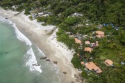 Picture taken with drone of Aventureiro Beach with a small fishing village - Angra dos Reis city - Rio de Janeiro state (RJ) - Brazil