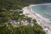 Picture taken with drone of Aventureiro Beach with a small fishing village - Angra dos Reis city - Rio de Janeiro state (RJ) - Brazil