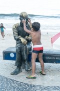 Child playing at the statue of the poet Carlos Drummond de Andrade on Copacabana Beach - Rio de Janeiro city - Rio de Janeiro state (RJ) - Brazil