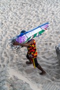 Workers at Arpoador Beach carrying sun umbrellas - Rio de Janeiro city - Rio de Janeiro state (RJ) - Brazil