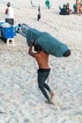 Workers at Arpoador Beach carrying sun umbrellas - Rio de Janeiro city - Rio de Janeiro state (RJ) - Brazil