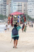 Street vendor with improvised sun umbrella as a display for selling bikinis on Copacabana Beach - Rio de Janeiro city - Rio de Janeiro state (RJ) - Brazil