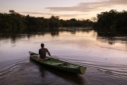 Man in canoe at sunrise at mamiraua Lake - Mamiraua Sustainable Development Reserve - Alvaraes city - Amazonas state (AM) - Brazil