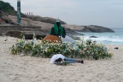 Offerings for Yemanja and a person sleeping on the sand during the party on the day of the Queen of the Sea - Arpoador Beach - Rio de Janeiro city - Rio de Janeiro state (RJ) - Brazil