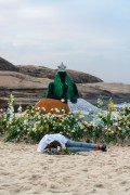 Offerings for Yemanja and a person sleeping on the sand during the party on the day of the Queen of the Sea - Arpoador Beach - Rio de Janeiro city - Rio de Janeiro state (RJ) - Brazil
